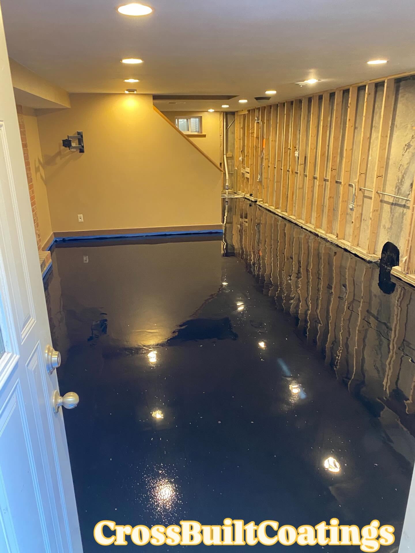 Before: freshly poured black epoxy base coat in an unfinished basement