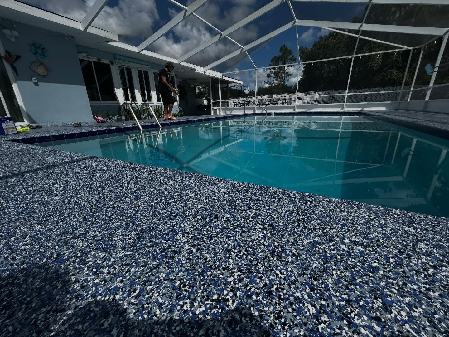 After: blue, black, and gray flake epoxy pool deck coating