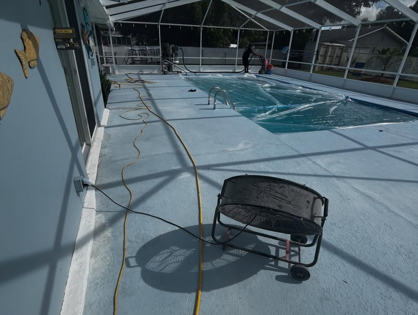 Before: faded painted pool deck being prepped