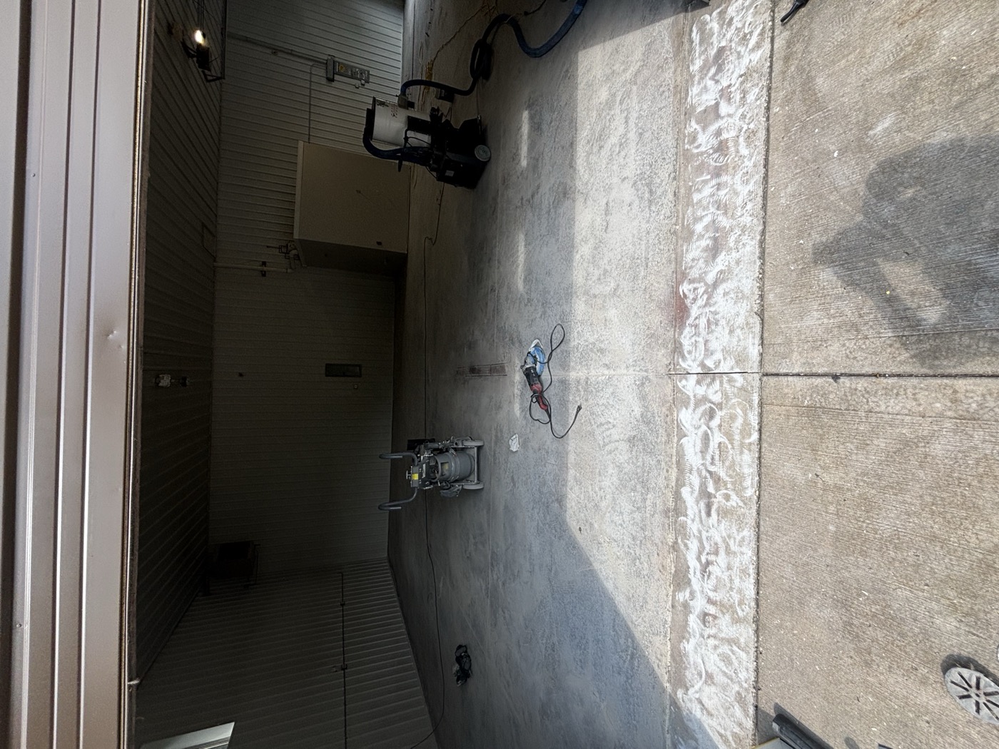 Before: bare concrete garage bay mid diamond-grind