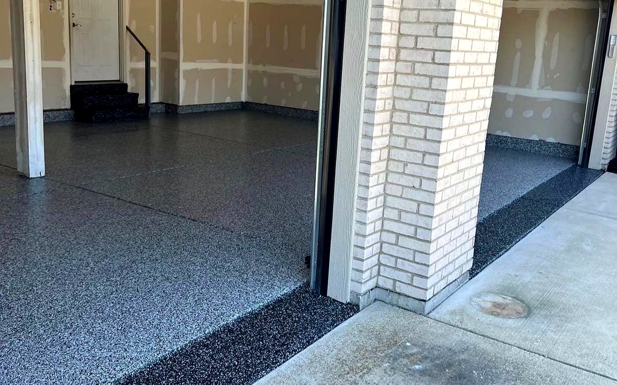 Real CrossBuilt job: gray and black flake epoxy coating across a two-bay garage