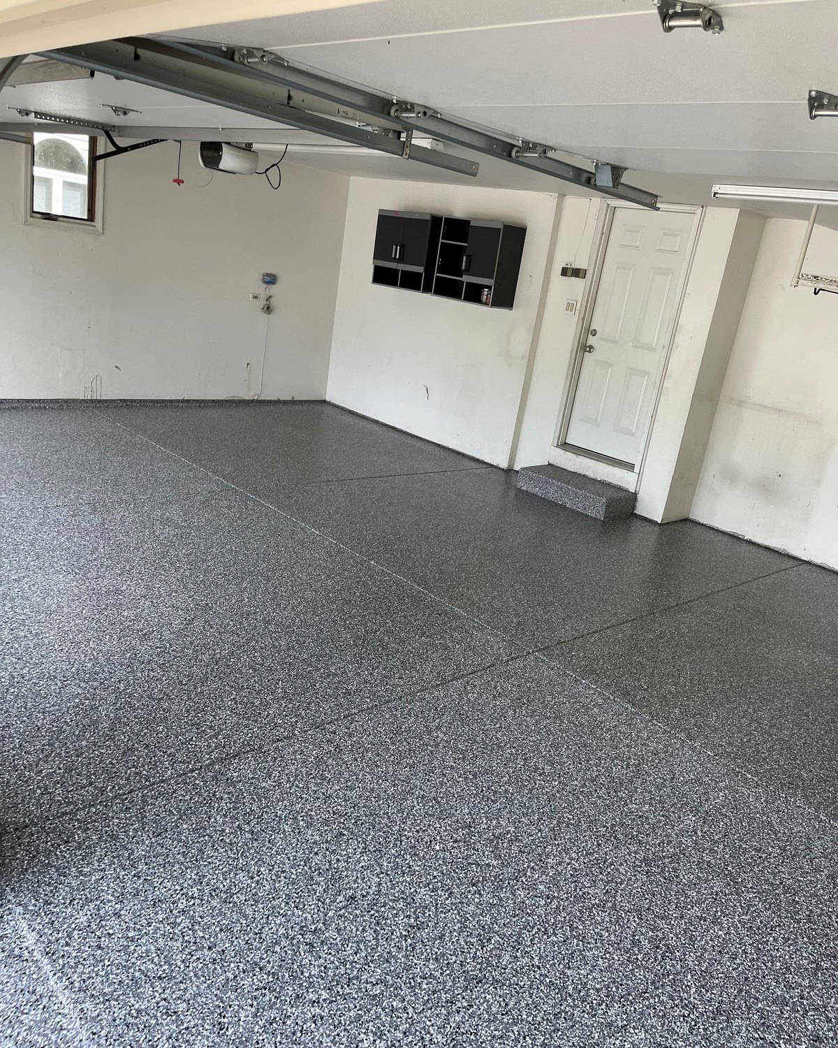 Gray and white flake epoxy floor in a finished two-car garage