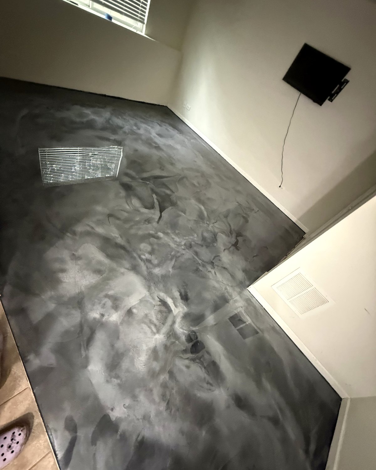 Charcoal and silver metallic epoxy floor in a finished basement room