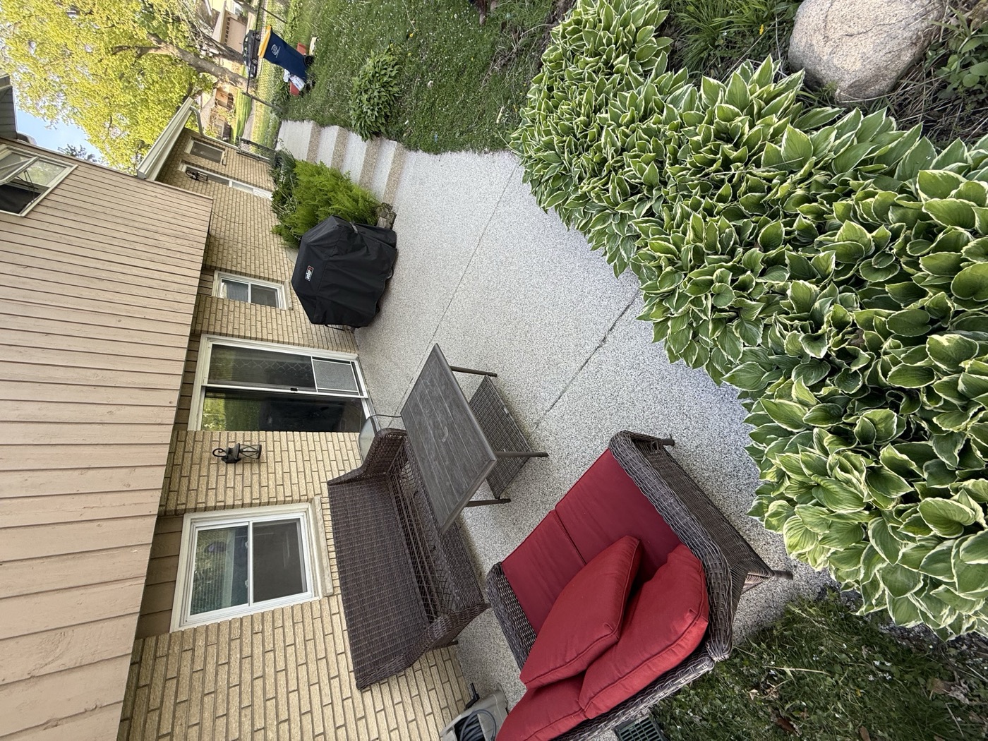 Flake epoxy coated backyard patio with outdoor furniture